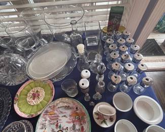 Decorative plates, silver shakers, and ceramic bowls