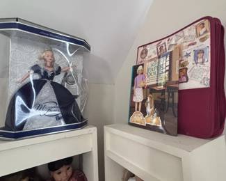 Collectible dolls in display cases