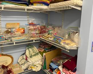 A closet, full of fabric, and crafting items