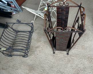 An array of cast iron and metal magazine racks and umbrella stands 