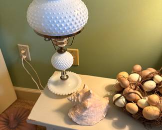 Lamp, shell & eggs in basket