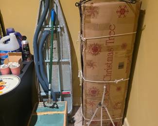 Ironing board, Rival ice cream churn, Christmas tree in box on right 