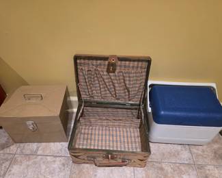 Left to right- metal container, picnic box, & small cooler