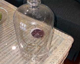 Glass bottle on wicker table 