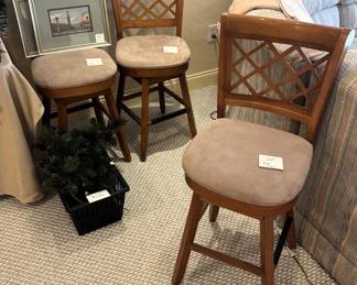 Three cushioned bar stools.