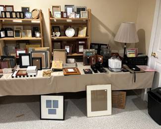 Large amount of picture frames and office supplies.