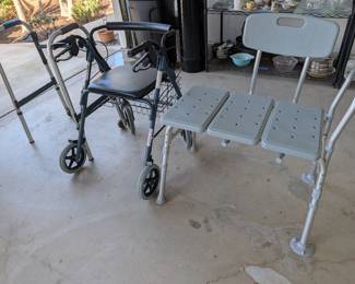 Mobility & Bath Safety: Sturdy bathtub transfer bench/shower seat, a standard walker, and a rolling walker with a seat and handbrakes.