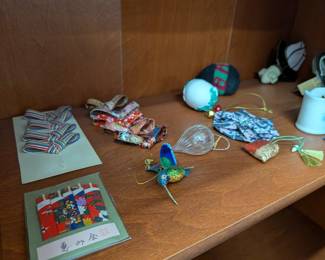 Small Decor & Collectibles: Assorted decorative items including a hummingbird figurine, Japanese-style fabric ornaments, and colorful beaded accents.