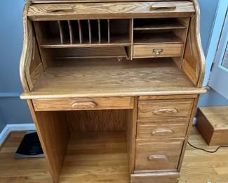 P83 - $150. Solid Wood Roll Top Desk. Measures 36" wide x 23" deep x 45.75" tall. Minor scratching on the top. Overall very good condition. 