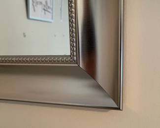 P12 - $30. Pair of Silver Framed Mirrors. Measures 21" wide x 25" tall.