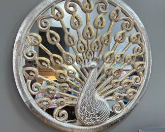 P35 - $35. Peacock Wall Mirror. Measures 23.5” diameter.