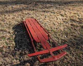P107 - $30. Red Wooden Sled with Metal Rails. 