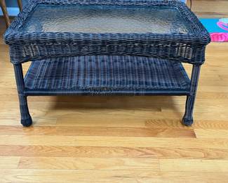 P87 - $40. Glass Top Coffee Table with indoor/outdoor plastic wicker look. Measures 30" x 17" x 17.5". 