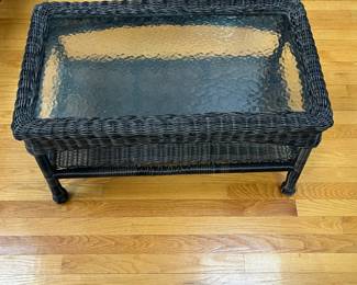 P87 - $40. Glass Top Coffee Table with indoor/outdoor plastic wicker look. Measures 30" x 17" x 17.5". 