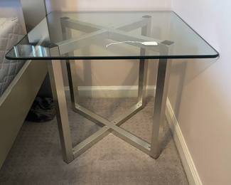 P15 - $40. Single Silver Framed Side Table with Glass Top. Was used next to a bed. Measures 24” wide x 24” deep x 20” tall.