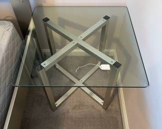 P15 - $40. Single Silver Framed Side Table with Glass Top. Was used next to a bed. Measures 24” wide x 24” deep x 20” tall.