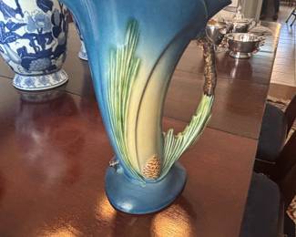 collectible item is a vintage Roseville Pottery vase in the blue Pine Cone pattern  