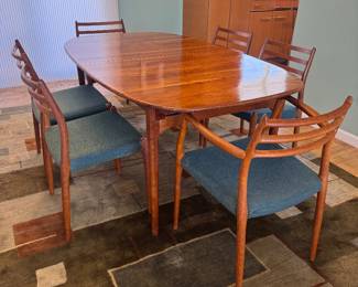 MCM Teak Extension Rounded Rectangular Dining Table with Hidden Leaf Storage (40"W x 28-1/2"H x 67-1/2"L with 2 - 15"L Additional Leaves) & Mobelfabrik Denmark Model 78 "Horned" Teak Dining Chairs with Linen Upholstered Seats Designed by Niels Otto Møller (19-1/2"W x 19-1/2"D x 31-1/2" Back Height) 2 Armchairs / 4 Side Chairs  