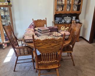 Pretty oak dining table with four captains chairs