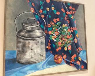 Framed Doyle painting featuring a still life scene of a rustic metal canister, a colorful floral fabric and a single fruit.