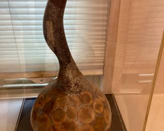 Decorative collectible, handcrafted, dried Gord featuring intricate patterns, and a lacquer finish.