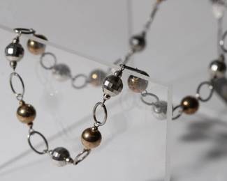 .925 Sterling Silver and 14kt gold filled Designer Necklace new old stock with tags by aura gento, approx 18" long with balls and links ending in lobster claw clasp total weight is 14.6 grams