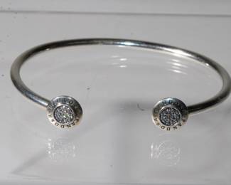 .925 Sterling Pandora Diamond Bangle Bracelet hallmarked .925 are inside bracelet and Pandora multiple times on each end cap surrounding a circle of diamonds on each side approx .40ctw, 8.6 grams total weight