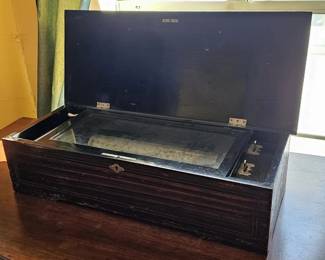 Antique 19th Century Mahogany Six Airs Swiss Mechanical Music Box. The top cover is decorated with inlay and marquetry formed as an instrument and sheet music. In good operating order, good tonal quality, comb complete.