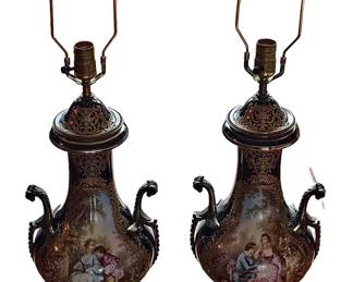 A Magnificent Pair of 19th Century French Servres Porcelain Lamps. Each one having applied bronze mounts and decorated with an elaborate hand painted scene of lovers in a garden against a royal blue ground. Both in excellent condition.
