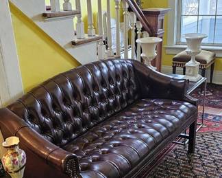 Pristine condition Chesterfield tufted leather sofa with upholstered buttons arranged in a quilted diamond pattern.
