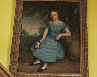 Mid 19th century American School oil on canvass depicting a young girl holding flowers in her right hand. Mounted in a heavily carved gilt frame.