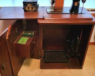 Antique Singer sewing machine in cabinet