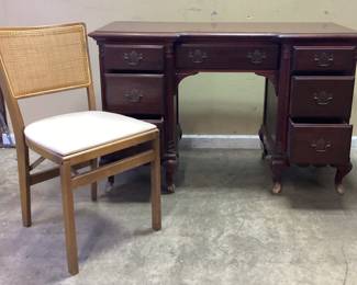 VTG. GEORGIAN MAHOGANY STYLE WRITING DESK WITH MCM STAKMORE CO. FOLDING CANE BACK CHAIR. DESK HAS DAMAGE AT FEET. NO SHIPPING PICKUP ONLY