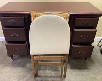 VTG. GEORGIAN MAHOGANY STYLE WRITING DESK WITH MCM STAKMORE CO. FOLDING CANE BACK CHAIR. DESK HAS DAMAGE AT FEET. NO SHIPPING PICKUP ONLY