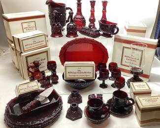 AVON THE 1876 CAPE COD COLLECTION RUBY RED GLASSWARE SET, FOOTED GLASSES, CANDLESTICK HOLDERS, DINNERWARE, PITCHER, DECANTER & STOPPER, BELLS, BUTTER DISH, 2-TIER SERVER, HEART TRINKET BOX NO SHIPPING PICKUP ONLY