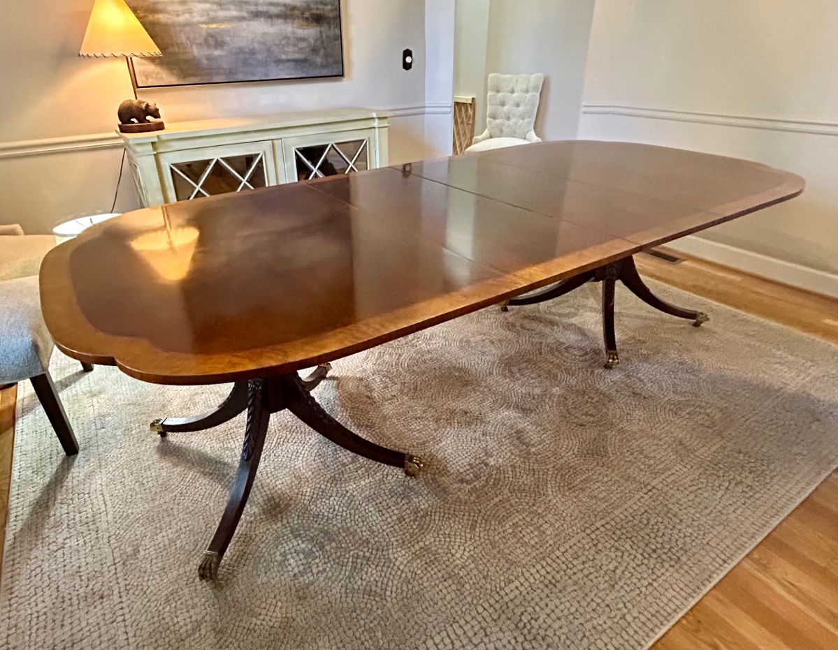 Baker Historic Charleston Collection Dining Table
This is a double pedestal dining table, mahogany, banded top with a shaped (almost scalloped) end profile, brass toe caps and casters. 