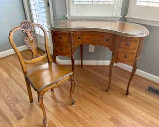 Vintage French Provincial Vanity Desk & Chair Set
Mid-Century curved “kidney” design with carved cabriole legs and hand-painted floral detail.
Includes matching chair and custom glass top protector.