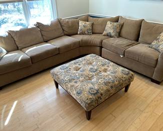 Sectional sofa with ottoman and matching pillows.