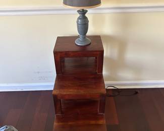 A pair of these 3 tier tables and lamps.