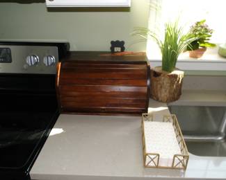 Rolltop breadbox, and a napkin holder in a sunny window