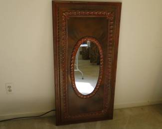 Oval mirror in large rectangular frame
