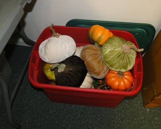 We have a bin filled with festive fall pumpkins and gourds, in a Christmas bin