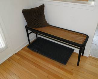 A welcoming bench, comfy pillow, and a shoe tray for those messy Michigan days