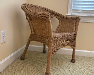R16 - $30. All weather woven wicker armchair in brown/natural finish. Measures 27" wide x 18" deep x 29" tall. 