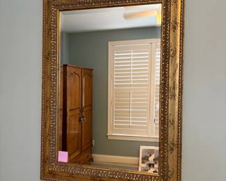 R48 - $45 Gold Framed Wall Mirror. Measures 27" wide x 37" tall. 