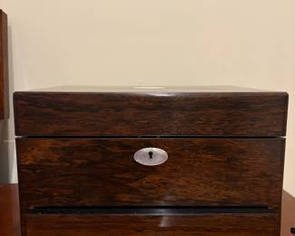 R38 - $325. Antique Victorian Traveling Vanity Box with Spring Loaded Drawer. Excellent Condition! Receipt from England Reads "1 Ebony & Silver Dressing Table Set. Received with Thanks". Approximately 11" wide. Metal lids & brush are Sterling Silver. 