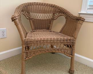 R16 - $30. All weather woven wicker armchair in brown/natural finish. Measures 27" wide x 18" deep x 29" tall. 