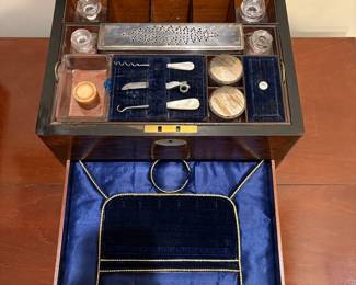 R38 - $325. Antique Victorian Traveling Vanity Box with Spring Loaded Drawer. Excellent Condition! Receipt from England Reads "1 Ebony & Silver Dressing Table Set. Received with Thanks". Approximately 11" wide. Metal lids & brush are Sterling Silver. 