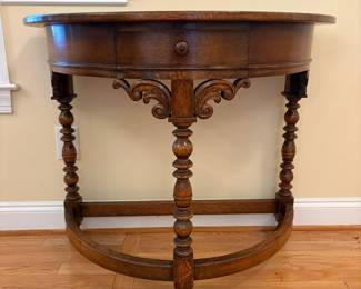 R22 - $325. English Entry Demi Lune Table. Measures 36" wide x 18" deep x 30" tall. Single Drawer slides easily. Purchased in England 80's/90's. ("Half Moon Oak Table" written on antique store tag.) 