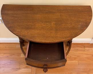 R22 - $325. English Entry Demi Lune Table. Measures 36" wide x 18" deep x 30" tall. Single Drawer slides easily. Purchased in England 80's/90's. ("Half Moon Oak Table" written on antique store tag.) 